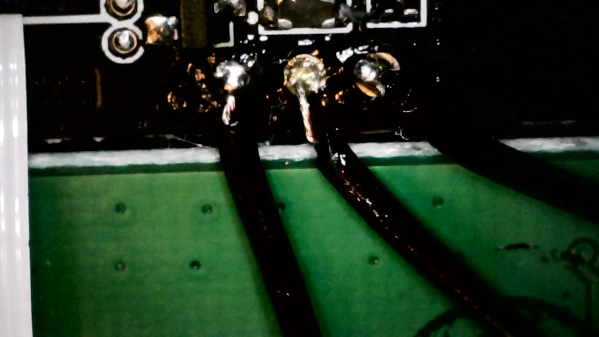 Three black wires run from the three solder pads. It's a messy job with a bit of flux left over.